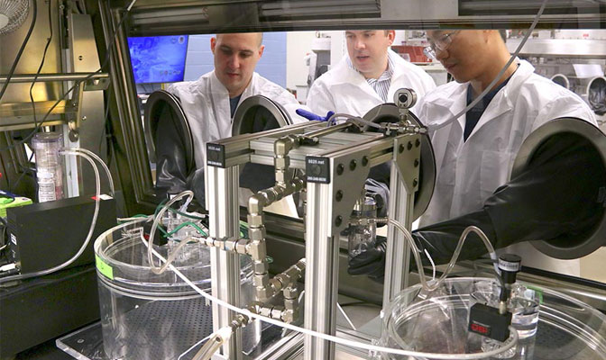 three male scientists in lab